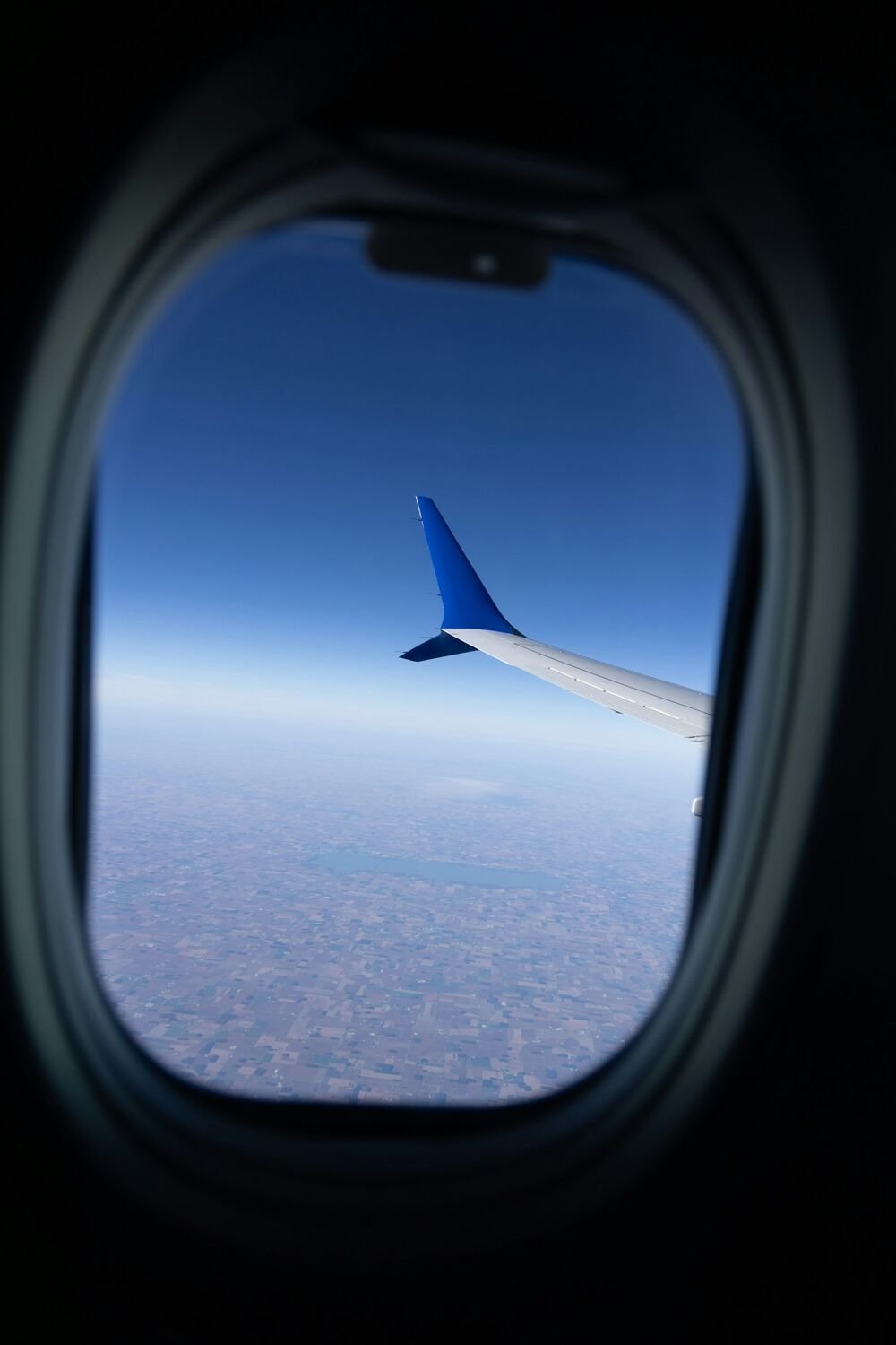 View from an airplane window above the clouds